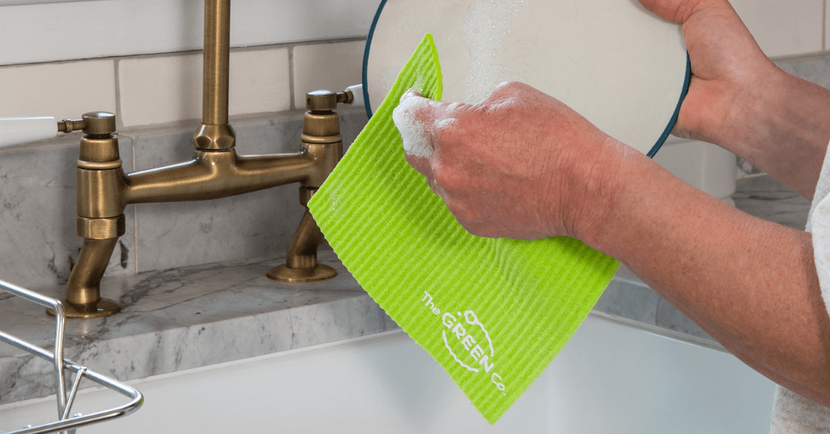 eco friendly household swap cellulose dish cloth washing dishes at kitchen sink