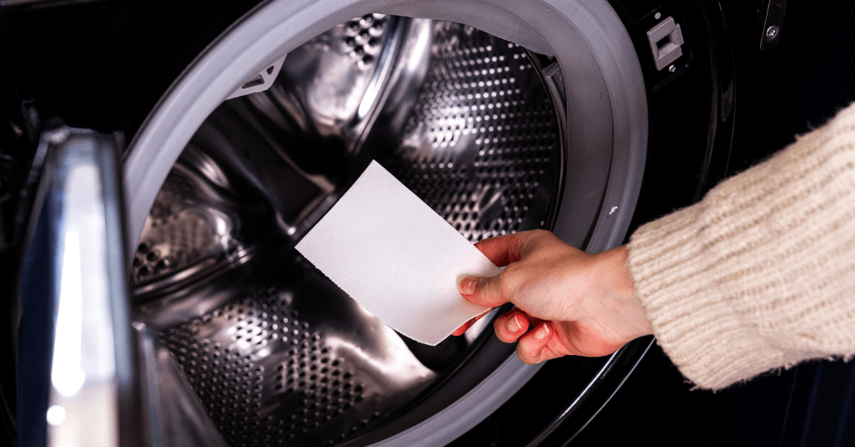 laundry detergent greensheet being placed into washing machine