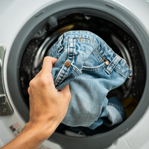 denim care guide featured image jeans being washed using eco friendly laundry detergent greensheets