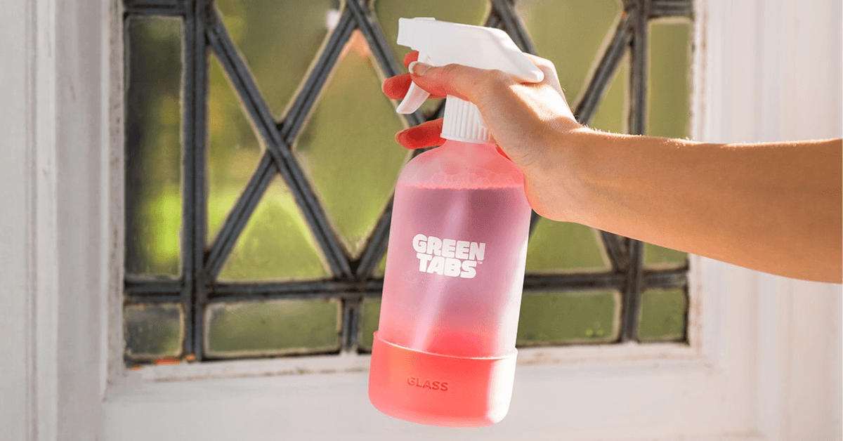 natural glass cleaner being sprayed onto window glass