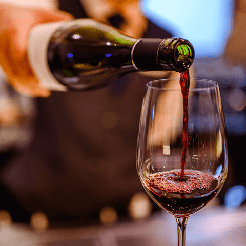 red wine being poured into wine glass