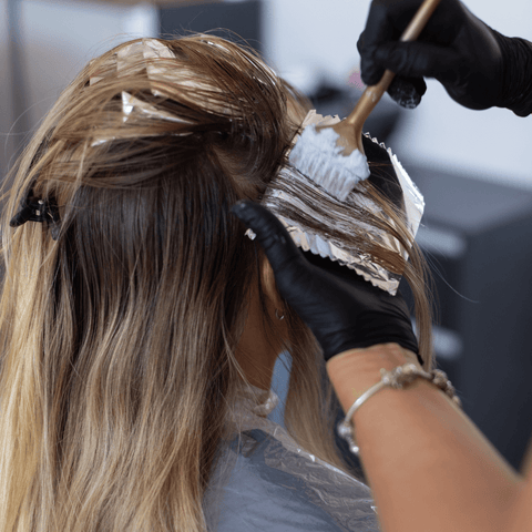 blonde women receiving professional hair dye application