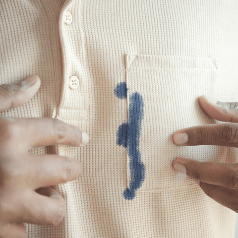blue ballpoint ink stain on white shirt