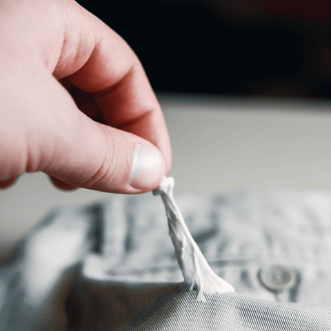 chewing gum stuck to blue linen shirt