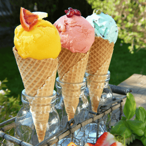 various coloured ice cream cones in garden setting