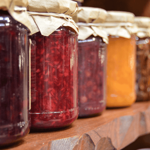 various kinds of jams preserved in glass jars