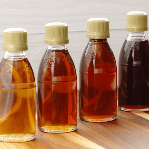 various coloured flavoured syrups in glass bottles