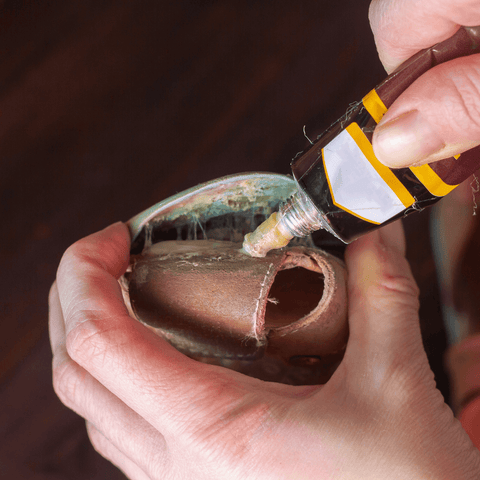 glue being used to glue leather pieces together 