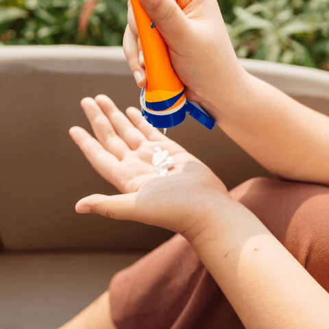 women dispersing sunscreen onto hands